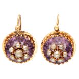 Antique 14K. yellow gold earrings with seed pearls set on purple colored stones.