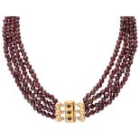 Vintage four-row garnet necklace with a 14K. yellow gold closure.