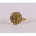 An 18 kt gold ring with a yellow rutile quartz and 30 brilliants and citrines