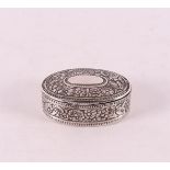 An oval 3rd grade silver powder box with flower decoration.