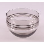 A clear glass bowl with horizontal stripes, design: Floris Meydam.