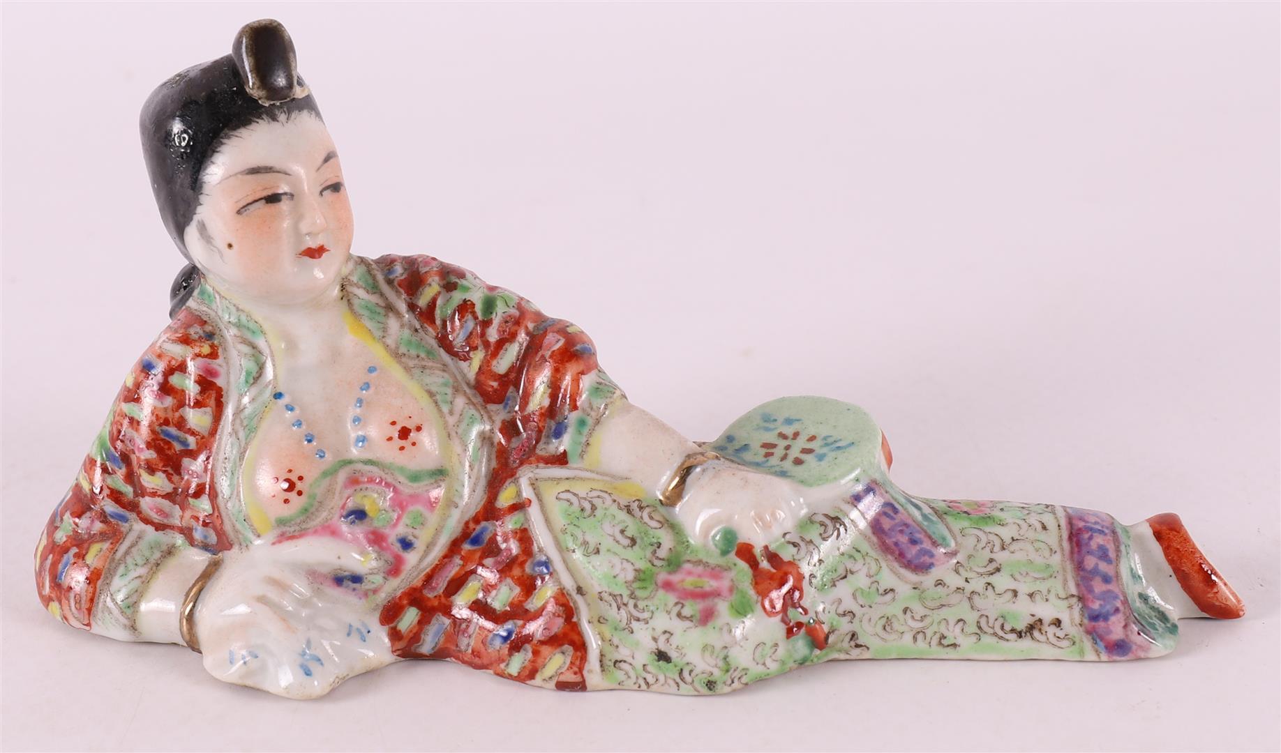 A porcelain reclining lady as a perfume bottle, China, circa 1900.