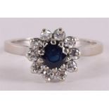 A 14 kt gold ring with a round facet cut blue sapphire and brilliant cut diamond