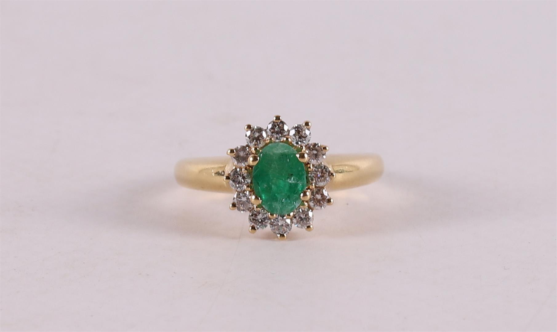 An 18 kt gold ring with an oval facet cut emerald.