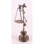 A silver trumpet-blowing angel on stand with equator