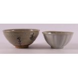 A gray stoneware Temoku bowl with text, Japan.