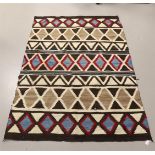 A traditional Navajo rug with geometric decor, 1st half 20th century.