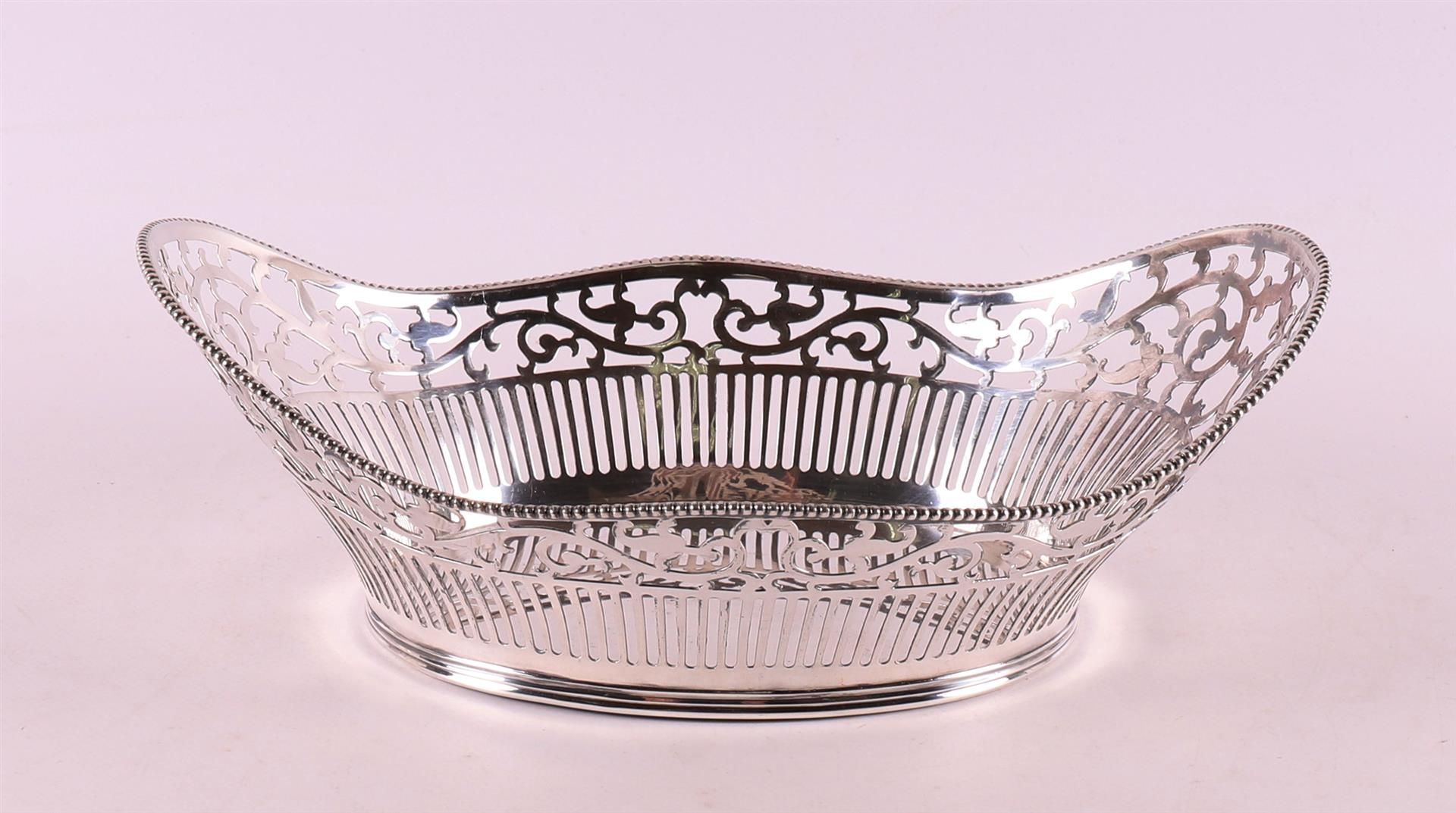 An ajour 2nd grade silver bread basket with pearl rim.