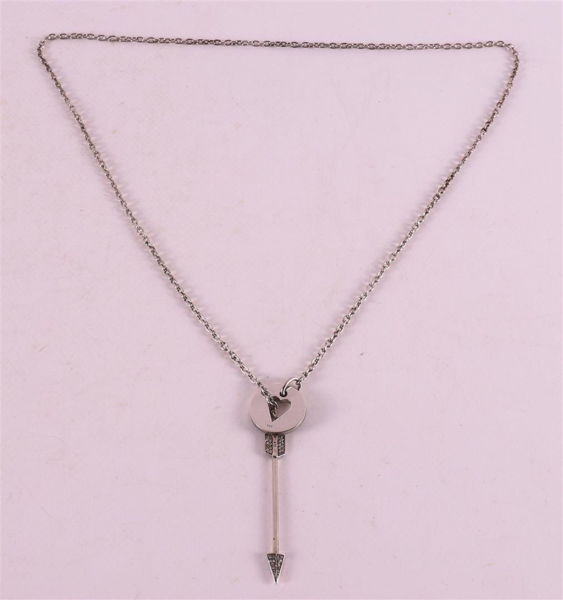 A first grade silver necklace with a cupid heart pendant and arrow with zirconia