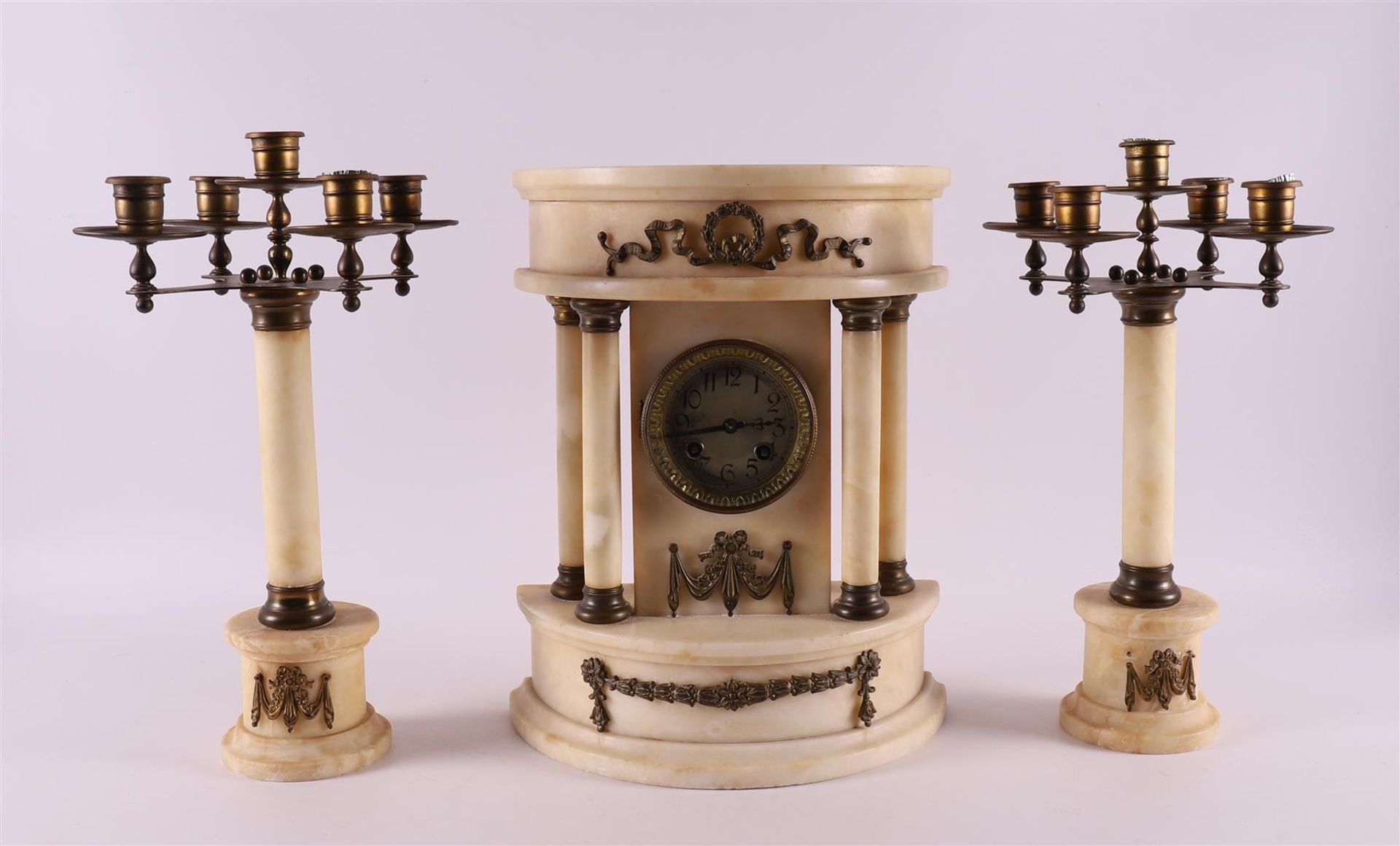 A three piece white alabaster mantel clock set, France. Louis XVI style, late 19