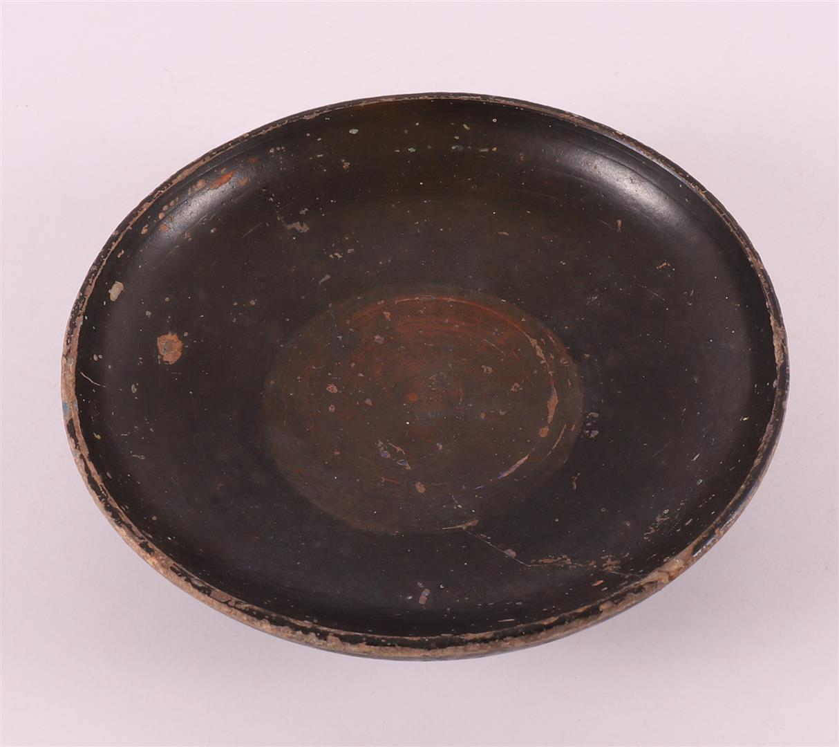 A black glazed earthenware bowl, Greece, 4th century b.c.