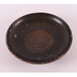 A black glazed earthenware bowl, Greece, 4th century b.c.
