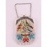 A 2nd grade silver purse bracket with beaded bag with bird decoration.