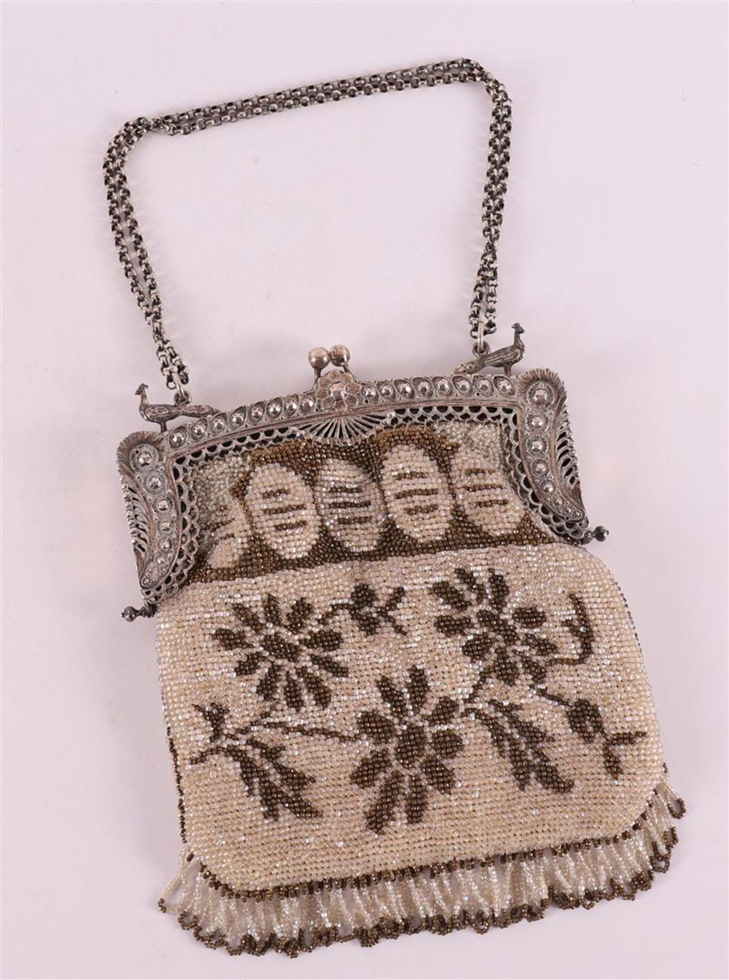A 3rd grade 800/1000 silver bag bracket with jasseron necklace, on a beaded bag.