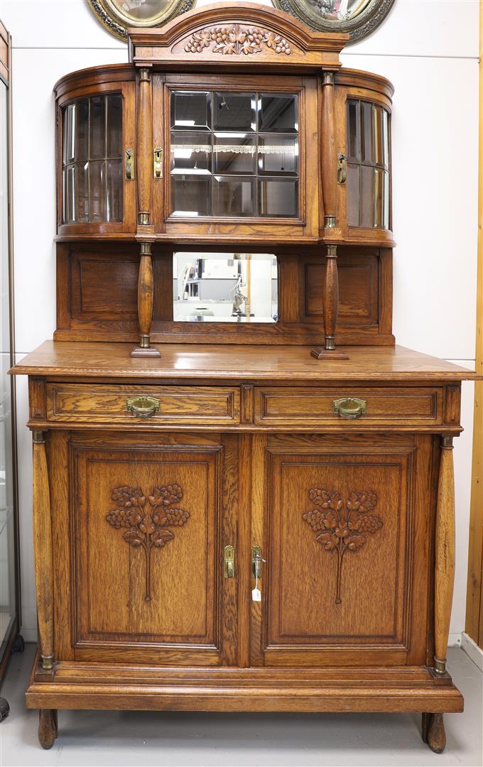 A sideboard with display case, early 20th century.