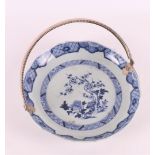 A blue/white porcelain contoured dish with silver handle, China