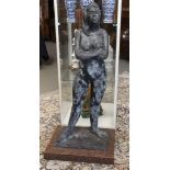 A bronze female standing nude on natural stone base, 20th century