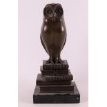 A brown patinated bronze owl sitting on books, Art Deco style.