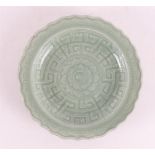 A celadon porcelain contoured dish, China, 17th/18th C.
