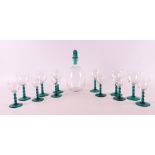 A clear glass liqueur decanter 'Omar' with green glass stopper and six glasses,