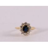 An 18 kt gold ring with an oval faceted blue sapphire.