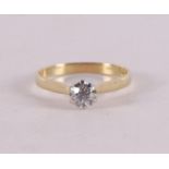A 14 kt gold solitaire ring with a diamond.