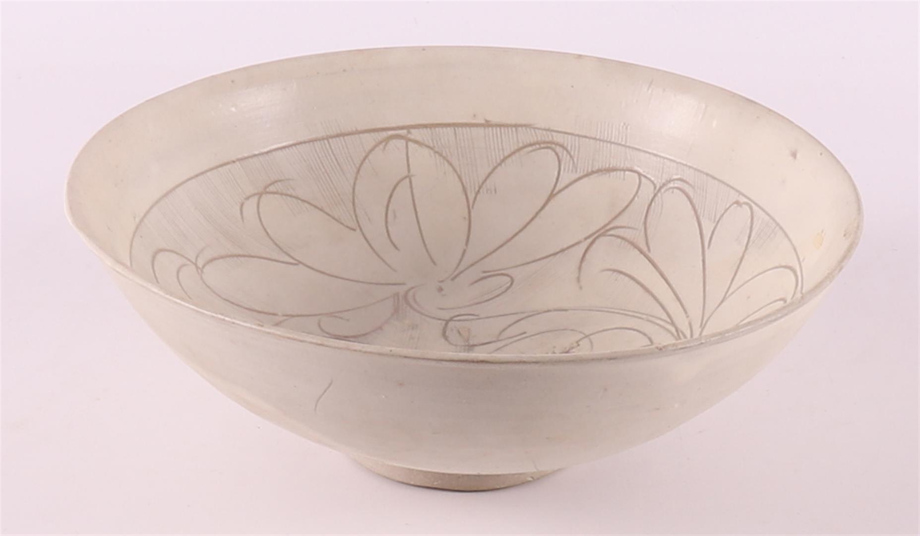 A white porcelain bowl with sgraffito decor, China, Sung, 12th/13th C.