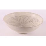 A white porcelain bowl with sgraffito decor, China, Sung, 12th/13th C.