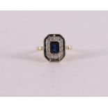 An 18 kt gold ring with 15 facet cut blue sapphires and 14 diamonds.