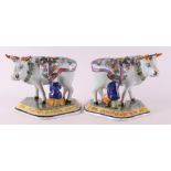 A set of polychrome earthenware cows with milkers, Porselyne bottle / Oud Delft.