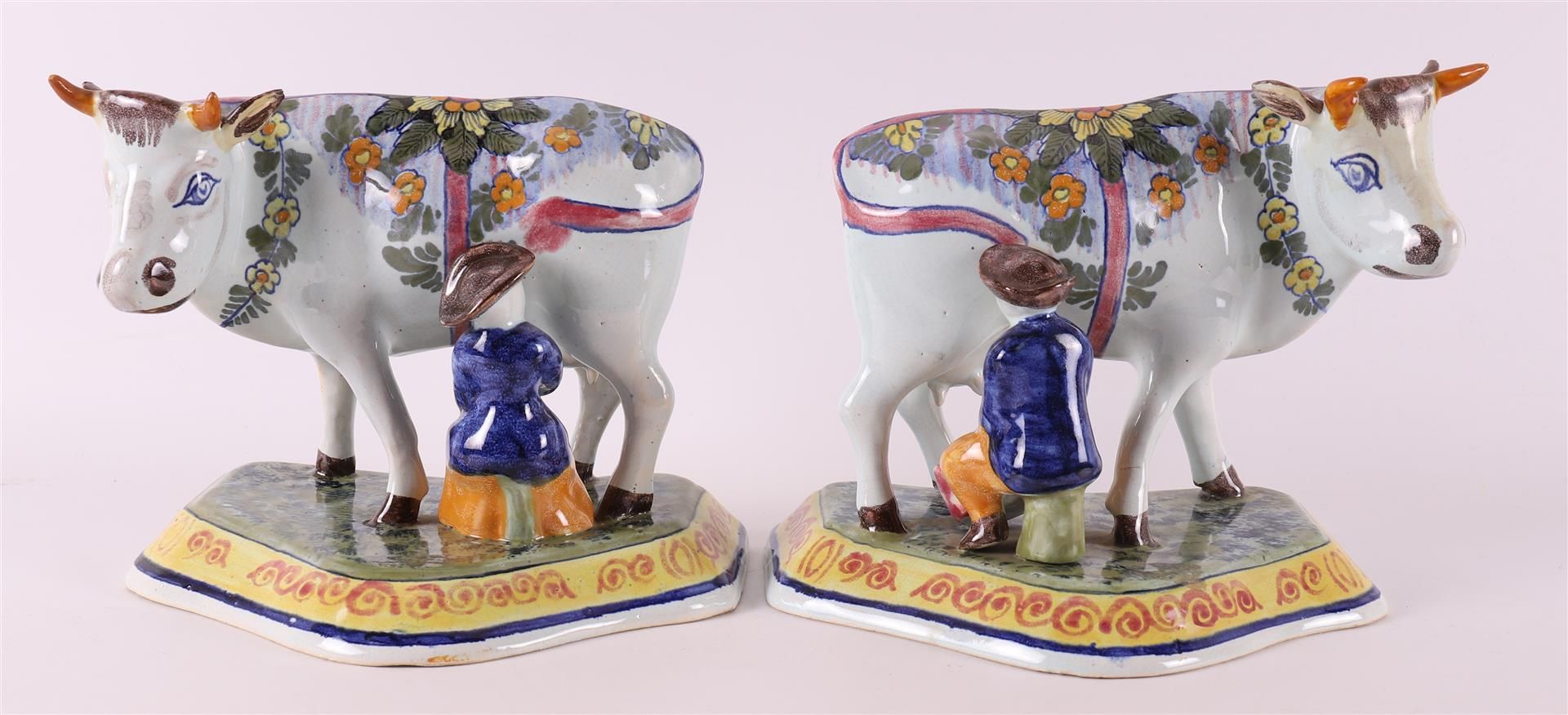 A set of polychrome earthenware cows with milkers, Porselyne bottle / Oud Delft.