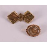 A 14 kt 585/1000 gold brooch with hair, regional costume dated 1884.