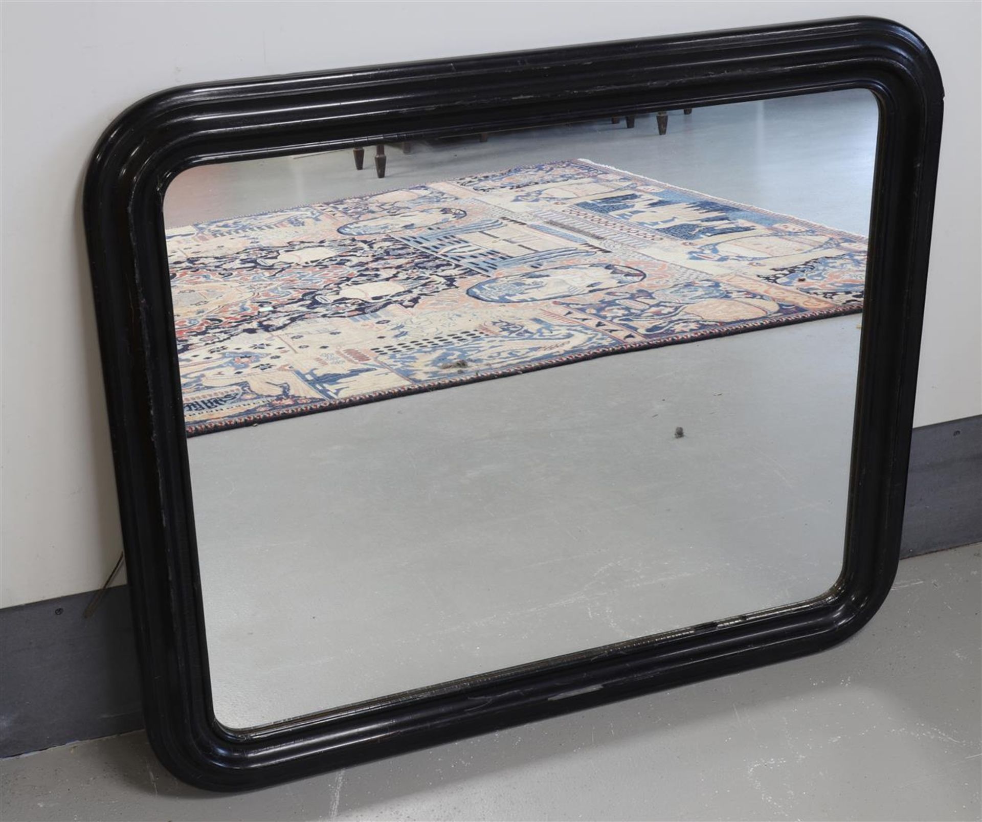 A mirror in a black lacquered profile frame, 19th century.