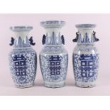 Three blue and white porcelain baluster vases with ears, China, around 1900.