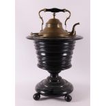 An ebonised tea stove on foot, second half 19th century.