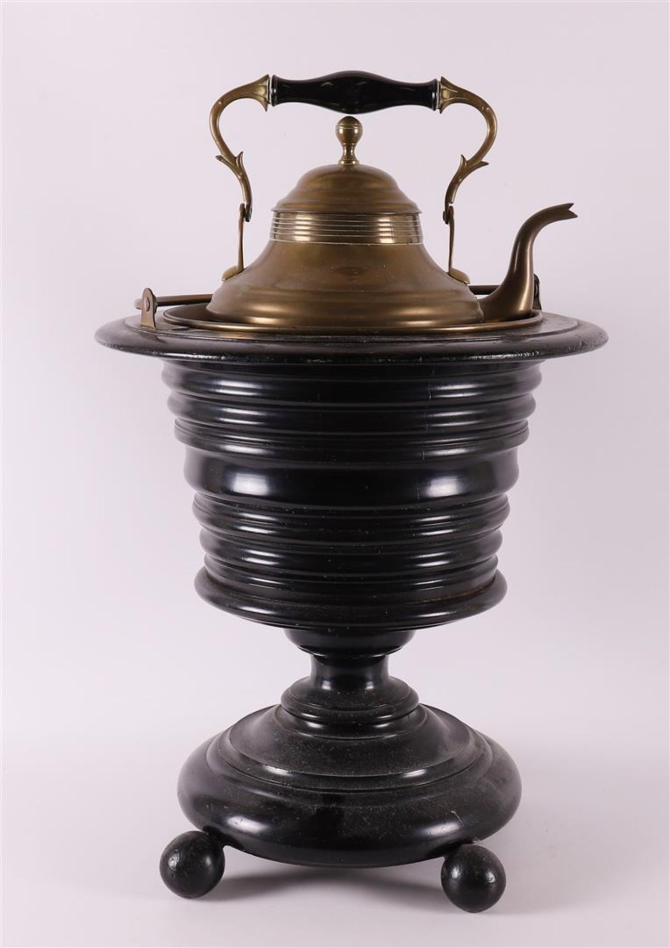 An ebonised tea stove on foot, second half 19th century.
