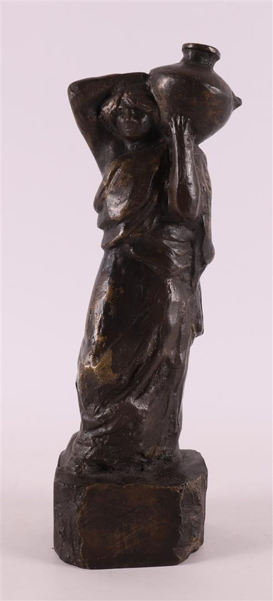 A brown patinated bronze Roman/Greek woman with jug on her shoulder.