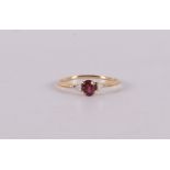 An 18 carat gold ring with an oval faceted ruby and 2 diamonds.