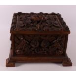 A carved wooden lidded box with relief decoration of roses, around 1900.