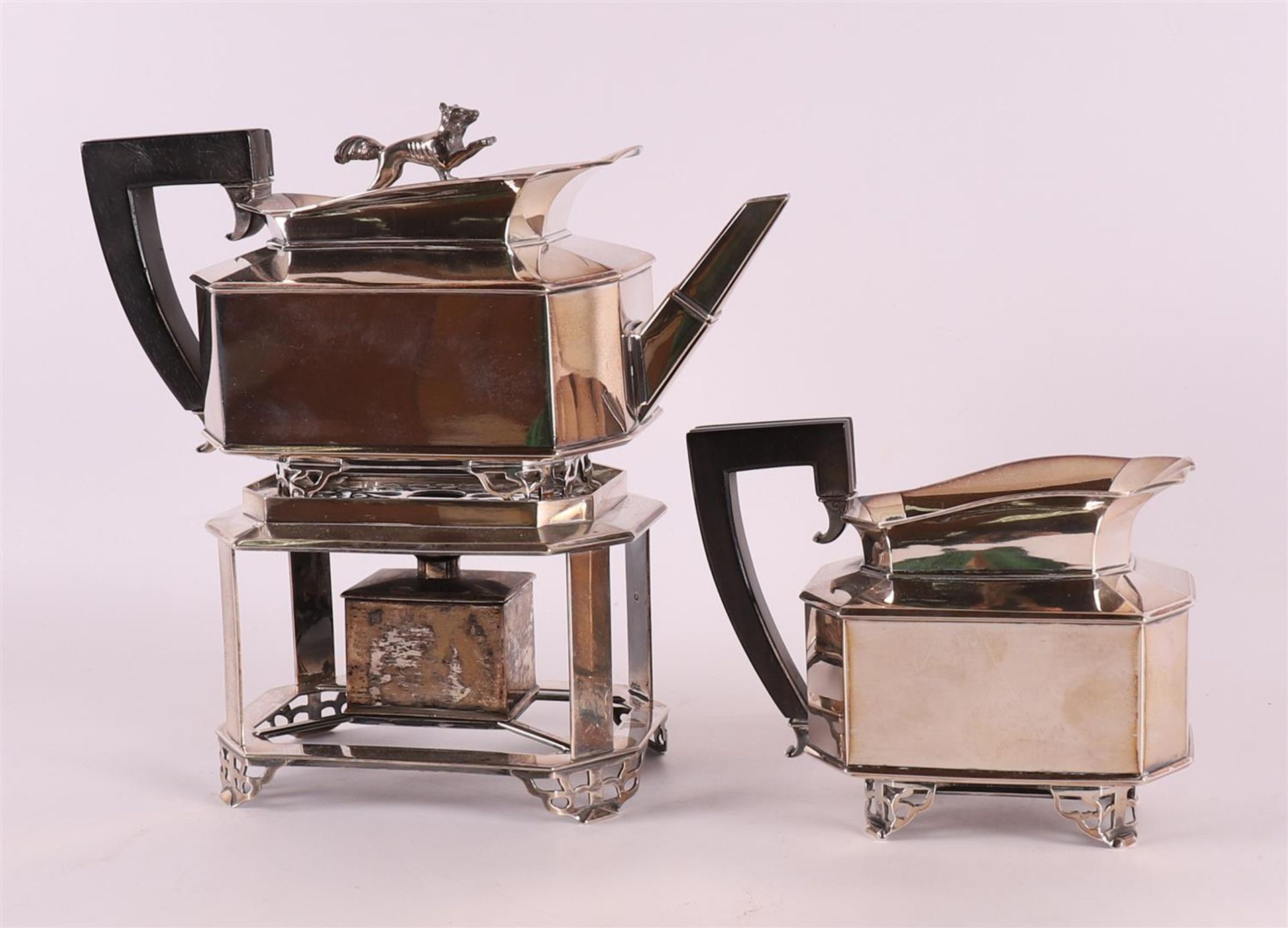 A silver teapot on matching chafing dish and milk jug, The Hague, 1849.