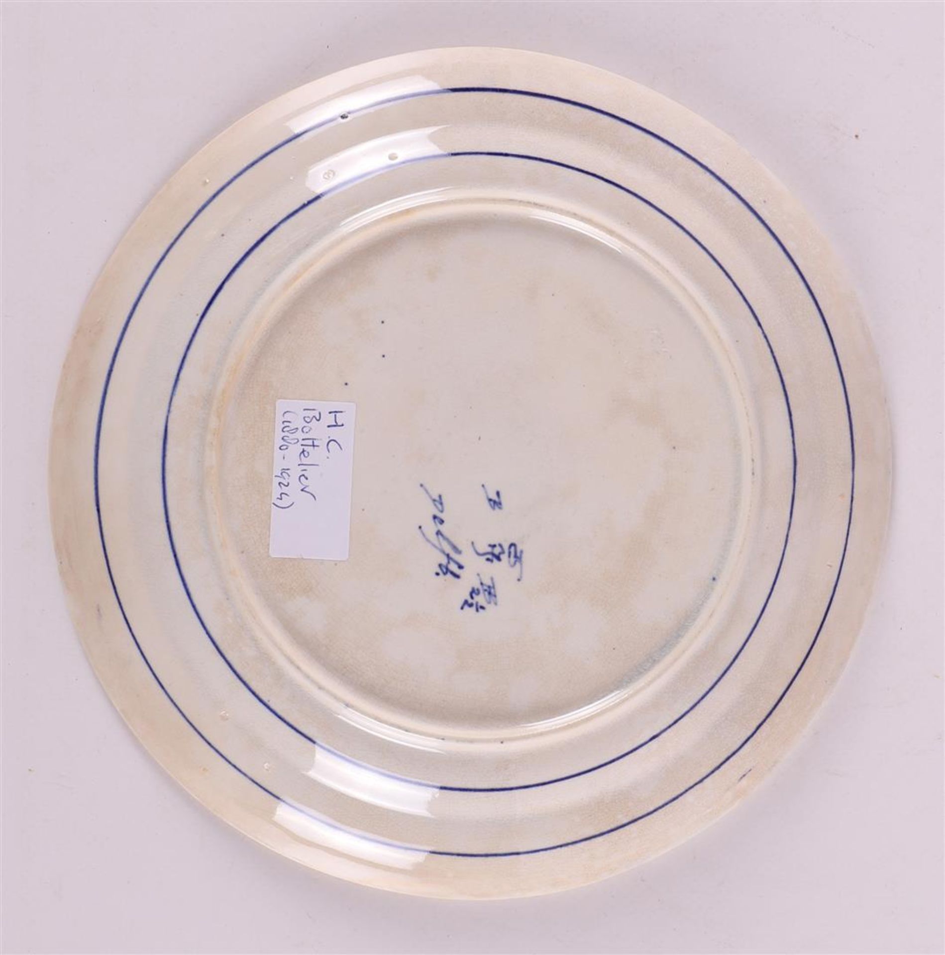 A blue and white earthenware plate depicting figures in a landscape, 19th centur - Image 2 of 2