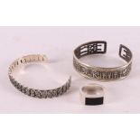 Two assorted rigid bracelets and a men's signet ring.