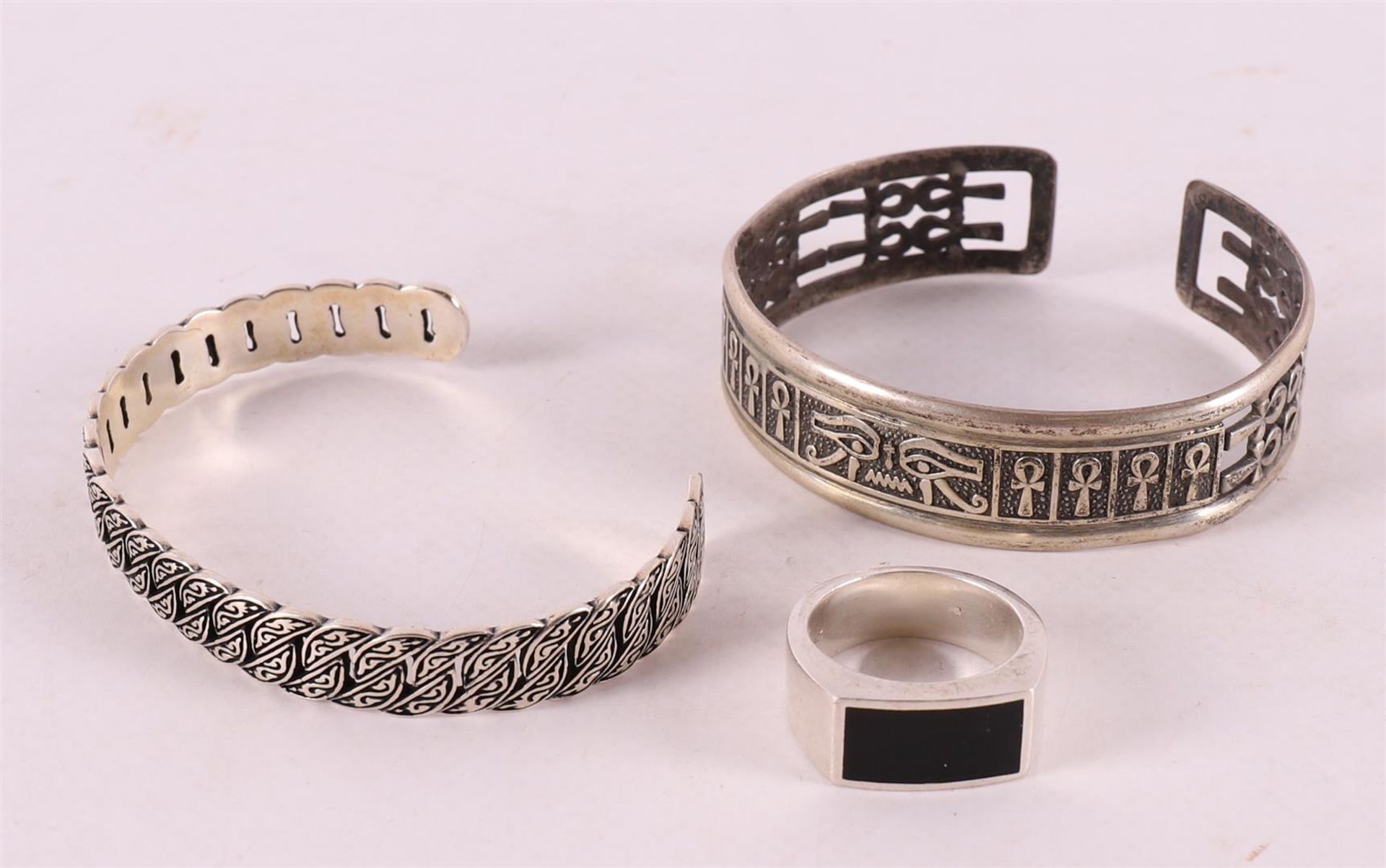 Two assorted rigid bracelets and a men's signet ring.