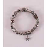 A sterling 925/1000 silver Pandora bracelet with 25 charms.