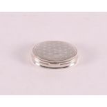 An oval second grade silver pill box, wavy decor with dots.