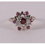 A 14 kt white gold women's ring, set with 7 rubies and 6 brilliants.