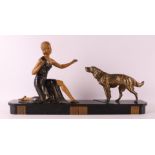 A white metal Art Deco sculpture of a woman with a hunting dog, France ca. 1920.