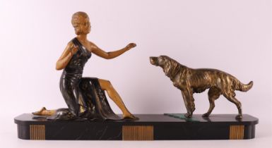 A white metal Art Deco sculpture of a woman with a hunting dog, France ca. 1920.