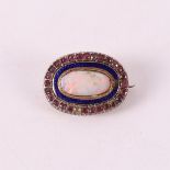 A 14 kt 585/1000 yellow gold oval brooch, set with opal and entourage.