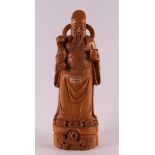 A carved tropical wooden priest with Ruyi sceptre, China, 20th century